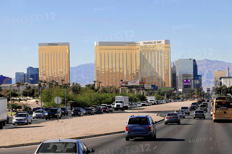 Las Vegas, Nevada, USA, North America, A busy street with cars and tall, gold-coloured buildings in the background, Las Vegas Strip, North America