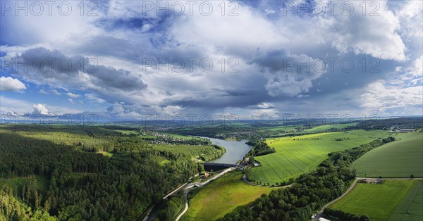 The Malter Dam is a dam built between 1908 and 1913 in the Free State of Saxony near the town of Malter, which impounds the middle reaches of the Rote Weisseritz. The dam is a curved gravity dam made of quarrystone masonry according to the Intze principle. It is an important element in flood protection up to the Elbe. Due to the current weather conditions, additional water is being drained off. Heavy rain showers and continuous rain are advancing from the Ore Mountains in the sky, Malter, Saxony, Germany, Europe