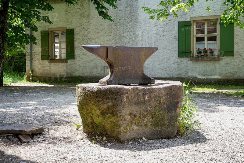 A classic anvil stands on a stone in front of a forge, Neuhausen ob Eck open-air museum, Tuttlingen district, Baden-Wuerttemberg, Germany, Europe