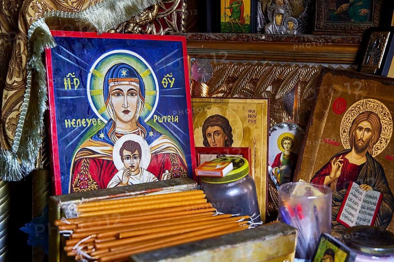 Rock chapel, Archangel Michael Panormitits, icons and religious objects on a devotional altar, illuminated by candles, Old Town of Rhodes, Rhodes Town, Rhodes, Dodecanese, Greek Islands, Greece, Europe