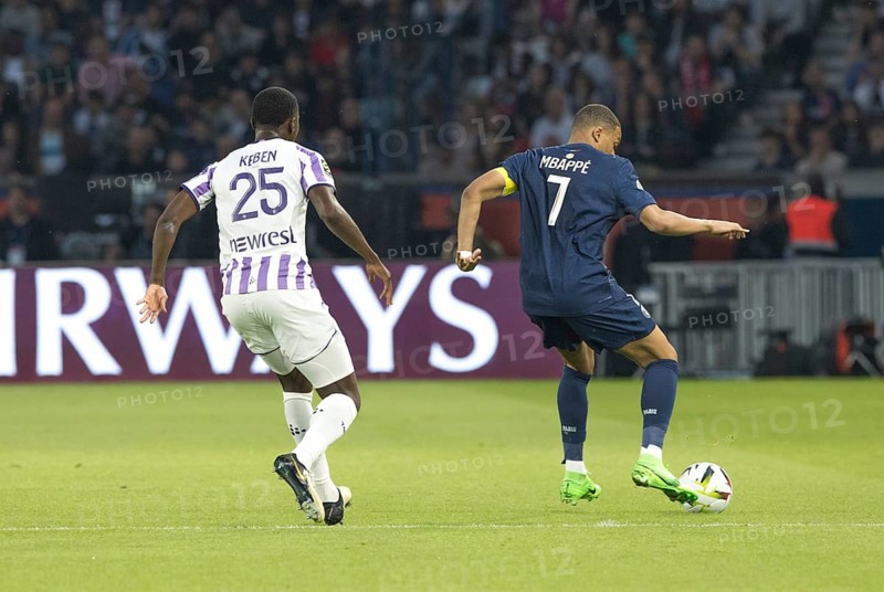 Football match, captain Kylian MBAPPE' Paris St. Germain right on the ball and Kevin KEBEN FC Toulouse in waiting position, both looking from behind, Parc des Princes football stadium, Paris, France, Europe