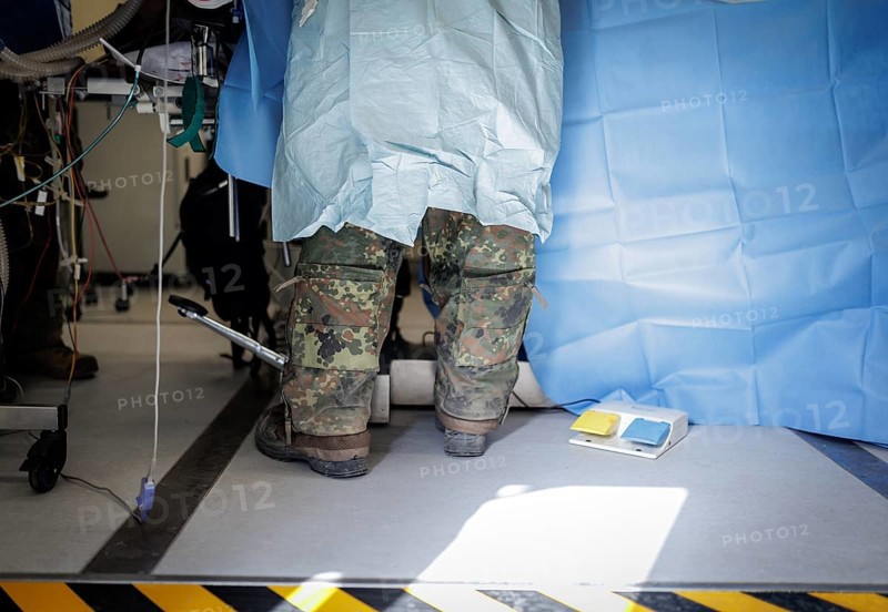 The legs of a Bundeswehr medical service soldier during a simulated operation on a casualty under operational conditions. Taken as part of the NATO large-scale manoeuvre Steadfast Defender and the German part of the exercise, Quadriga 2024, in Pabrade, 29.05.2024