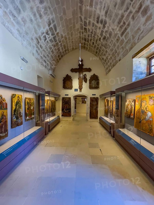 Entrance area with showcases and large wooden cross on wall in vaulted museum Monastery museum in UNESCO World Heritage Site orthodox monastery Moni Arkadi Arkadi monastery from early Middle Ages, important national monument national shrine on island of Crete, Arkadi, Armnatos, Crete, Greece, Europe