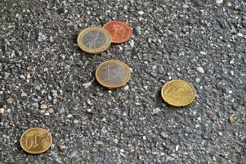 Money lying on the street, two one euro pieces, 20 cent, 10 cent, 5 cent