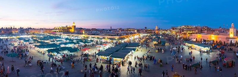 Marrakech, Morocco, March 27, 2018: Panoramic high angle dusk view over Jemaa El-Fna square at evening in historic old town medina, Africa