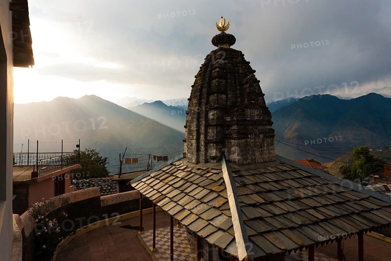 A minor temple at Bhimakali Temple complex overlooks the view of the Himalayas in Sarahan, Himachal Pradesh, India. Horizontal
