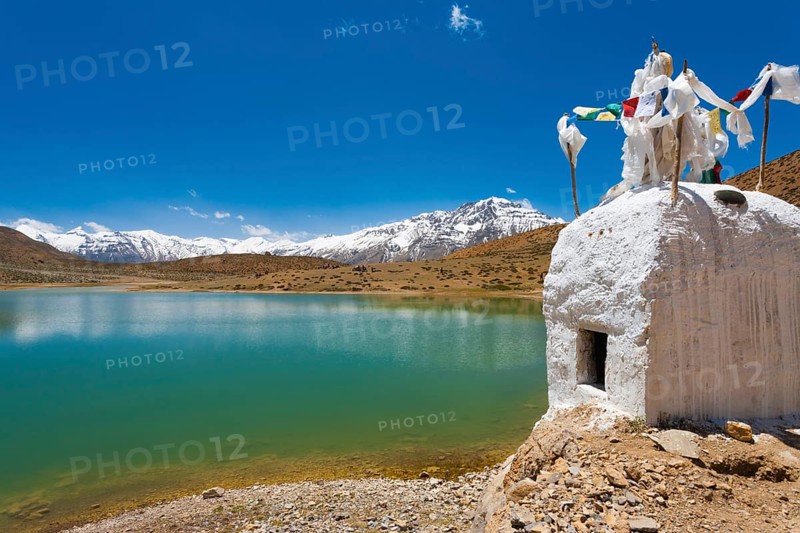 A stupa stands at the edge of a pristine mountain lake used by Buddhist pilgrims near Dhankar, Spiti Valley, Himachal Pradesh, India, Asia