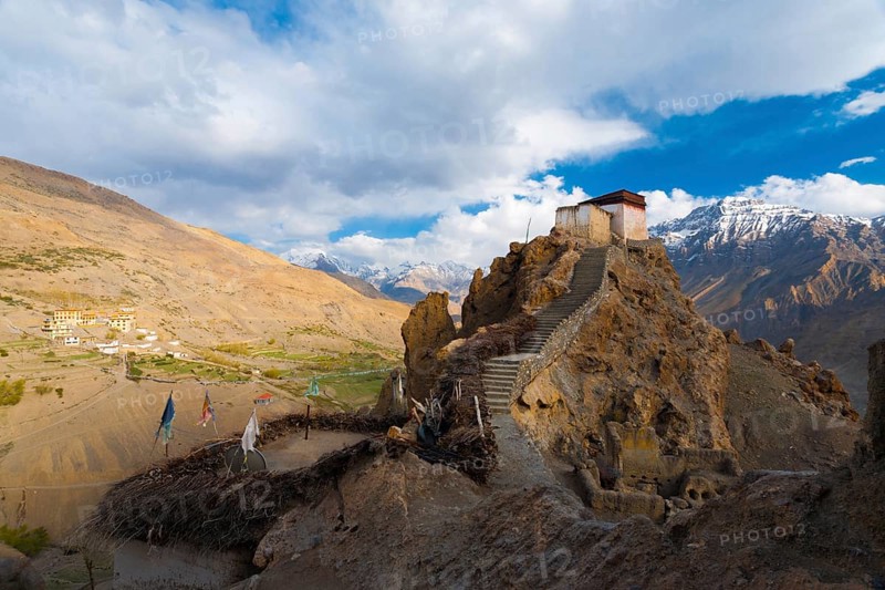 A wide view of the watchtower at the old monastery and its commanding view of the new monastery, mountains and Spiti valley below in Dhankar, Himachal Pradesh, India, Asia