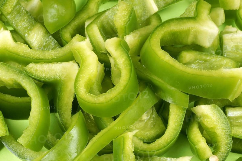 Organic background made of green bell pepper slices