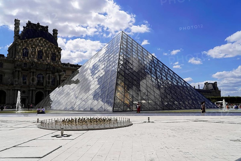 Glass pyramid in the courtyard of the Palais du Louvre, Paris, France, Europe, Historical buildings and the glass pyramid of the Louvre in sunny weather with few people around, Europe
