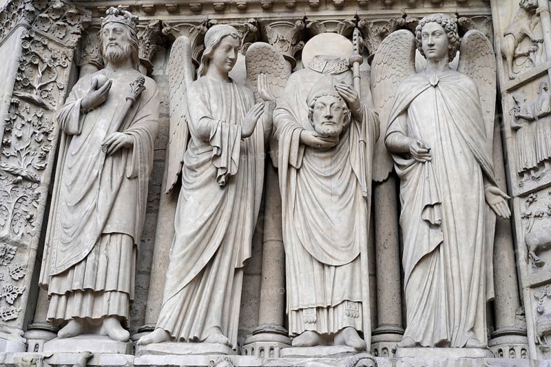 Figures of saints, Detail of the Gothic entrance portal of Notre Dame de Paris Cathedral, Paris, France, Europe, Detailed stone carvings on the façade of a Gothic cathedral with sculptures of saints and angels, Europe