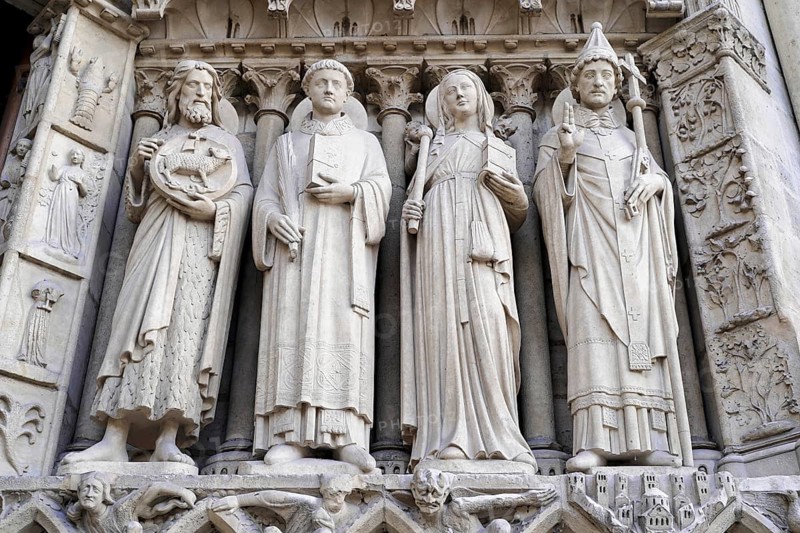 Figures of saints, Detail of the Gothic entrance portal of Notre Dame de Paris Cathedral, Paris, France, Europe, Detailed stone carvings with sculptures of saints on the façade of a Gothic cathedral, Europe