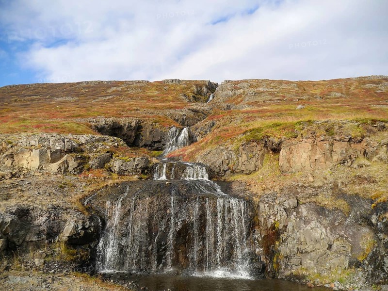 Autumn landscape with waterfall at Isafjordur in the northwest of Iceland