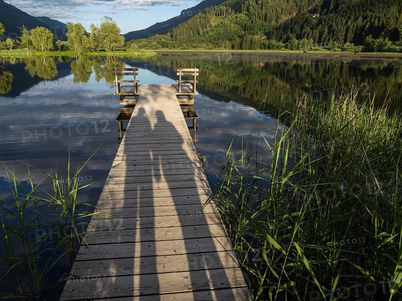 Shadow of a couple on a jetty, Gaishorner See in the evening light, Gaishorn am See, Paltental, Styria, Austria, Europe