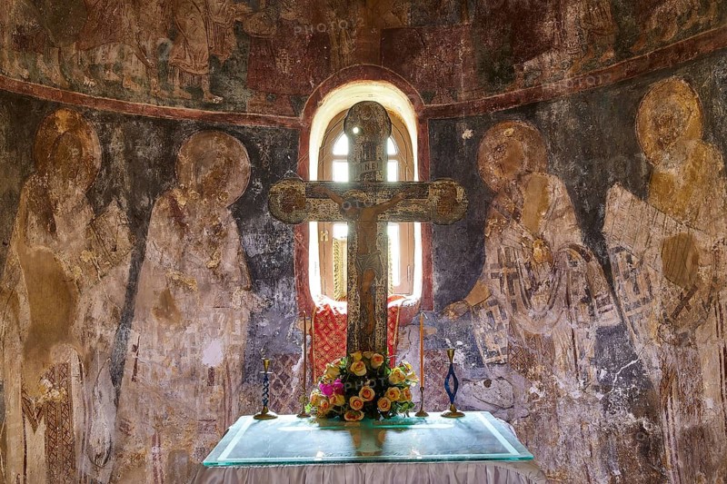 Altar with a cross and flowers in front of an artistically painted wall in an old church, chancel, Byzantine chapel Agios Nikolaos Foundoukli, between Eleousa and Profitis Ilias, Rhodes, Dodecanese, Greek Islands, Greece, Europe