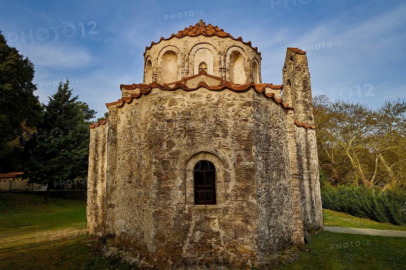 Old stone church in the middle of a forest, with red tiled roof and blue sky in the background, Byzantine chapel Agios Nikolaos Foundoukli, between Eleousa and Profitis Ilias, Rhodes, Dodecanese, Greek Islands, Greece, Europe
