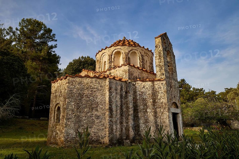 A small church with stone walls and red bricks, surrounded by trees under a blue sky, Byzantine Chapel of Agios Nikolaos Foundoukli, between Eleousa and Profitis Ilias, Rhodes, Dodecanese, Greek Islands, Greece, Europe