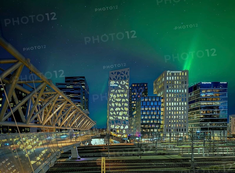 Barcode neighbourhood with acrobats pedestrian bridge night northern lights Oslo Norway