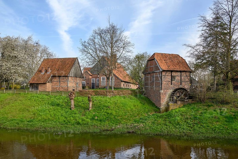 Small historic village with farmhouses, windmill and a river with a water wheel in a rural landscape, Vreden, North Rhine-Westphalia, Germany, Europe