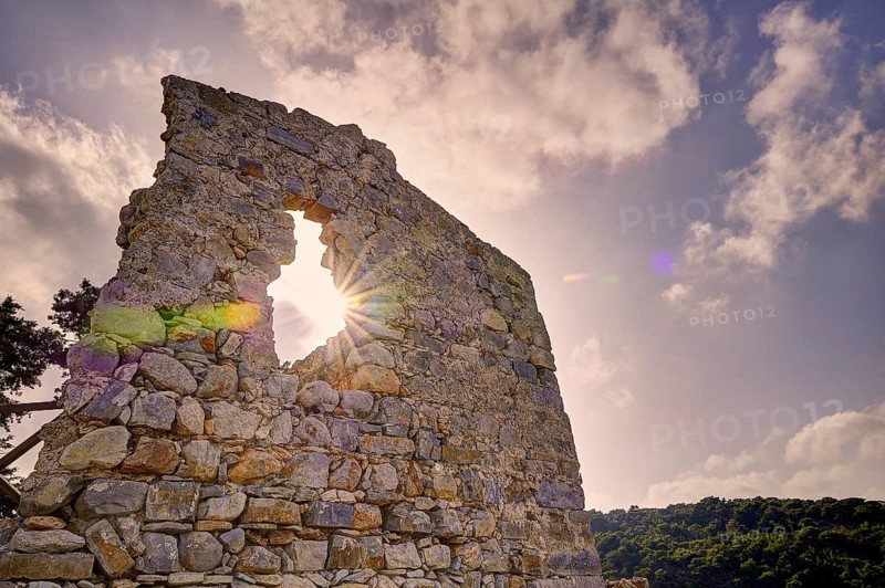 Stone wall of the ruin with a hole through which the sun shines, surrounded by cloudy sky, Kastro Monolithou, Monolithos Castle, rock castle, Monolithos village, Rhodes, Dodecanese, Greek Islands, Greece, Europe