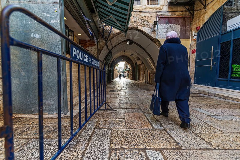 Historic street in the old town of Jerusalem with Police barrier