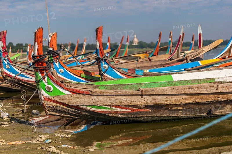 Colourful boats in front of the U Bein bridge
