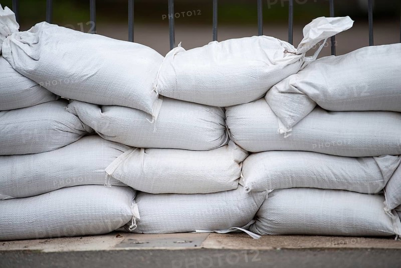 Sandbags for flood defense, river Moselle Trier in Rhineland Palatinate, flooded trees and paths, high water level, climate change
