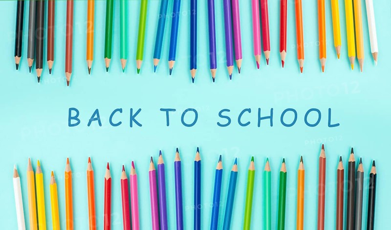 Color pencils collection in a row, back to school, drawing supplies, blue background with copy space