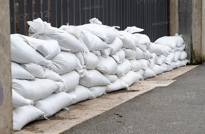 Sandbags for flood defense, river Moselle Trier in Rhineland Palatinate, flooded trees and paths, high water level, climate change