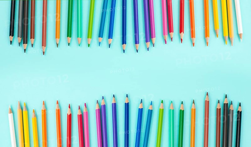 Color pencils collection in a row, back to school, drawing supplies, blue background with copy space