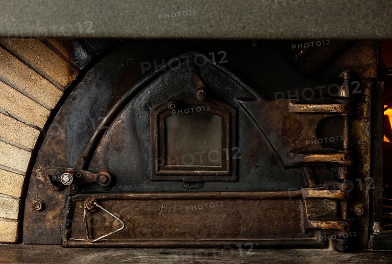 Antique wood oven with cast iron door