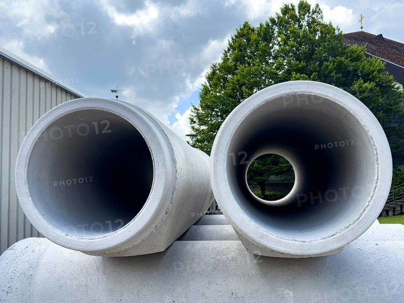 Two stored concrete pipes Concrete pipes laid in concrete for sewer construction Laying of sewer for road construction, Germany, Europe