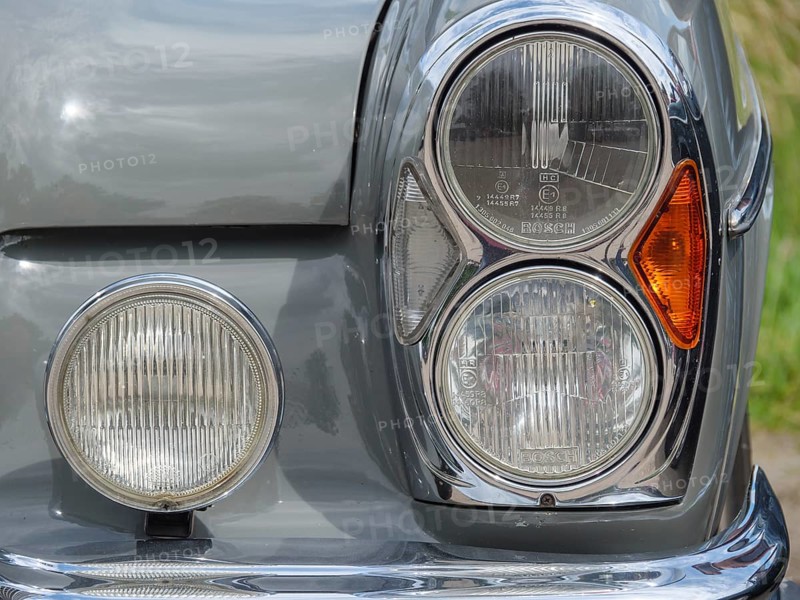Close-up of a grey vintage car, showing the headlights and chrome trim, winterswijk, gelderland, the netherlands