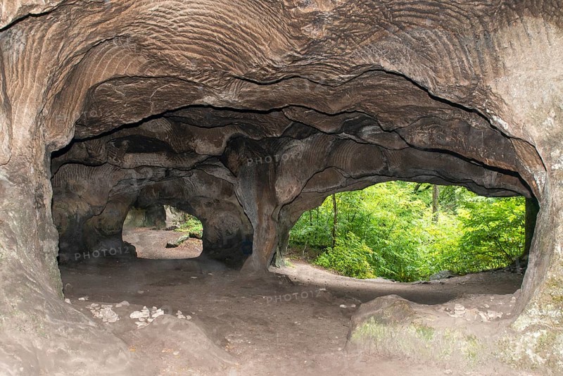 El Huel Lee or Hohllay on the Mullerthal trail in Luxembourg, open cave with view to the forest, sandstone rock formation