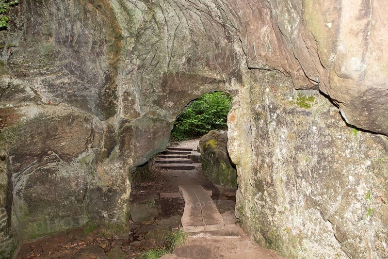 Huel Lee or Hohllay on the Mullerthal trail in Luxembourg, open cave with view to the forest, sandstone rock formation