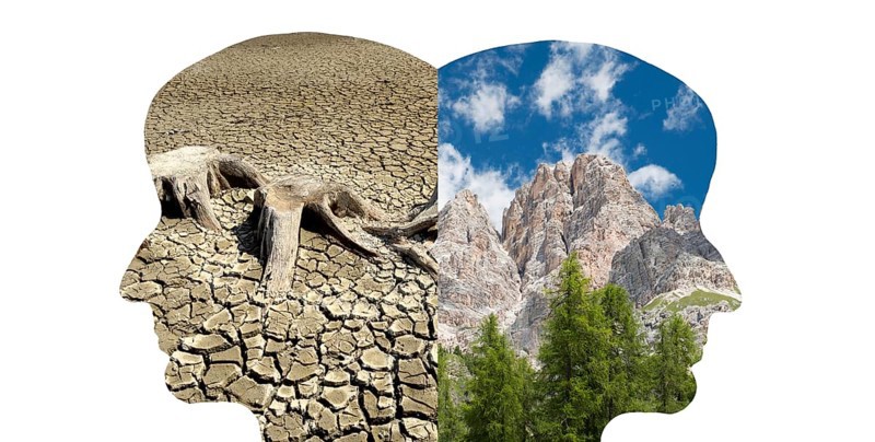 Silhouette of two faces look to the opposite direction, one with green nature, mountains, the other one with a dry river bed, climate change, future vision