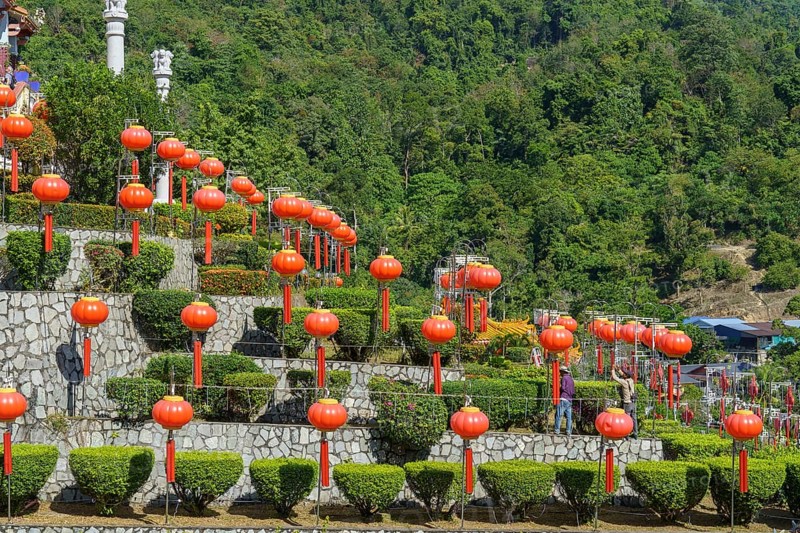 Stairs decorated with many lanterns and plants in the background of green mountains, Pattaya, Thailand, Asia