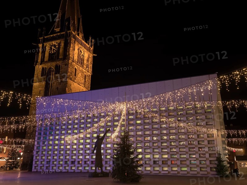 Illuminated Christmas market decoration at night with lights and a large tower in the background, Ahaus, Münsterland, North Rhine-Westphalia, Germany, Europe