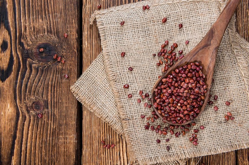 Dried red beans on dark rustic wooden background