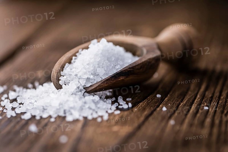 Coarse Salt (selective focus, close-up shot) on a dark vintage background