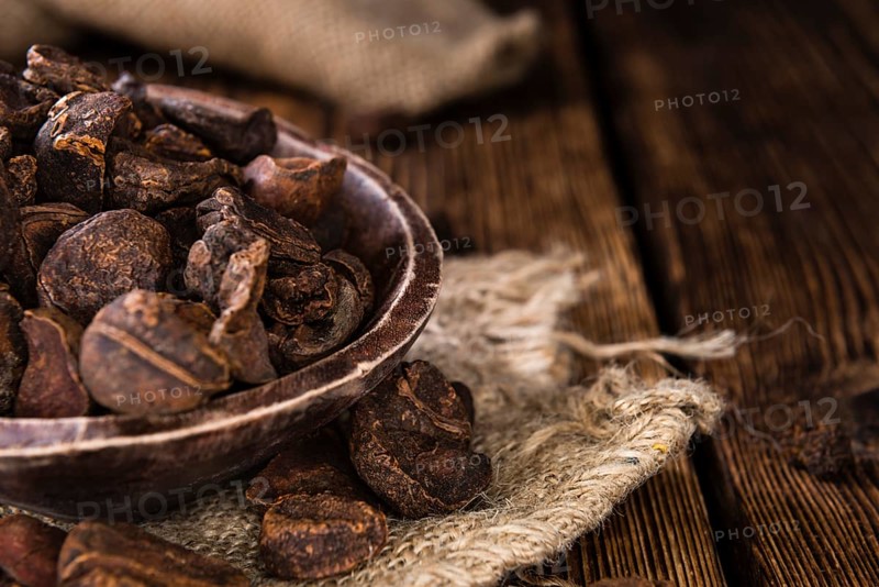 Dried Cola Nuts (whole ones) on vintage wooden background