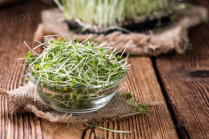 Fresh Cress (close-up shot) on rustic wooden background