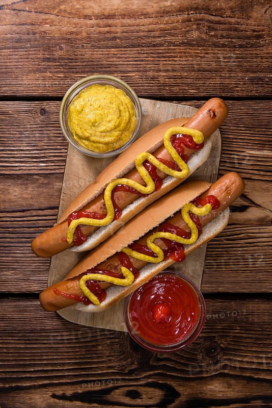 Homemade Hot Dog with ketchup and mustard on rustic wooden background