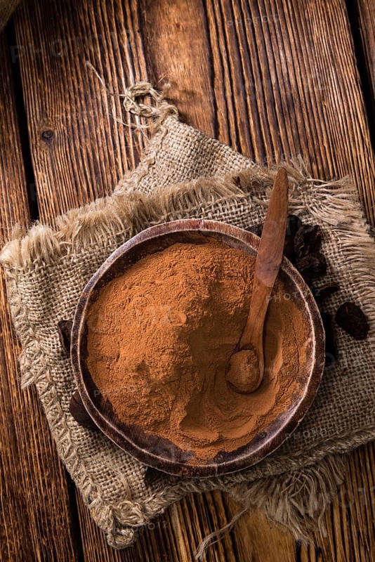 Portion of milled Cola Nut (close-up shot) on wooden background