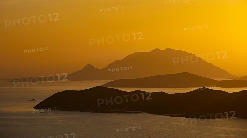 Golden sunset over the sea with silhouetted mountains in the background, Makri Island, Alimia Island, Chalki Island, Kritinia Castle, St John's Castle, Kritinia, Rhodes, Dodecanese, Greek Islands, Greece, Europe