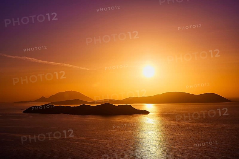 Violet-golden sunset over calm sea and silhouetted islands, Makri Island, Alimia Island, Chalki Island, Kritinia Castle, St John's Castle, Kritinia, Rhodes, Dodecanese, Greek Islands, Greece, Europe