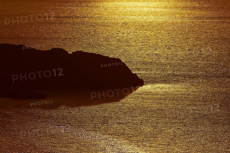Coastal silhouette in golden light, calm sea reflecting the sunset, Kritinia Castle, St John's Castle, Kritinia, Rhodes, Dodecanese, Greek Islands, Greece, Europe