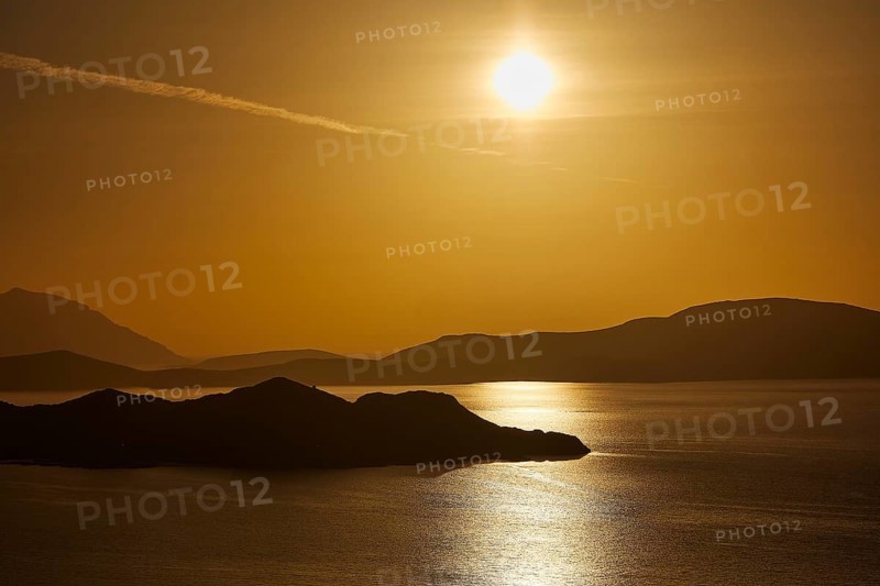 Golden sunset over calm sea with silhouetted archipelago, Makri Island, Alimia Island, Chalki Island, Kritinia Castle, St John's Castle, Kritinia, Rhodes, Dodecanese, Greek Islands, Greece, Europe