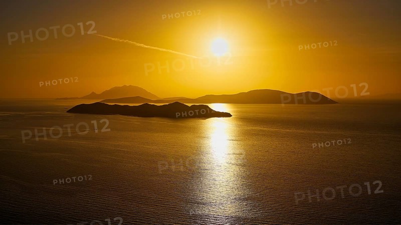 Sunset over calm sea with islands in golden light, Makri Island, Alimia Island, Chalki Island, Kritinia Castle, St John's Castle, Kritinia, Rhodes, Dodecanese, Greek Islands, Greece, Europe
