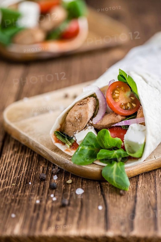 Chicken Wrap (close-up shot, selective focus) on vintage wooden background